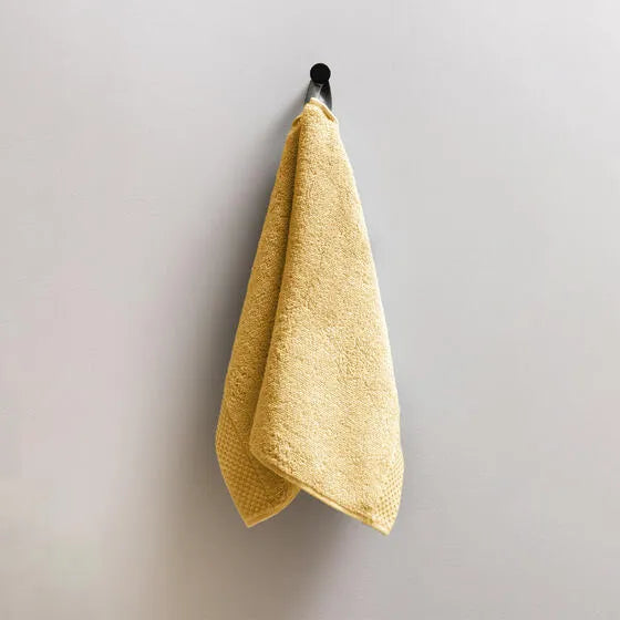 Luxe oker Florence gastendoeken (3 stuks) van 100% GOTS-katoen, 600 g/m², hoge kwaliteit, zacht en absorberend.